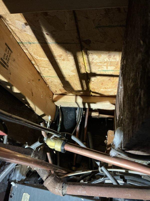 Responded to a service call for a frozen and split copper water line that supplies the upstairs bathroom and laundry. Created an 8x8 access hole to reach the damaged pipe, which had previously been improperly repaired with a wrap. Successfully replaced the broken section of copper pipe, restoring water flow to the upper level. Customer was informed that drywall repair services are not included.