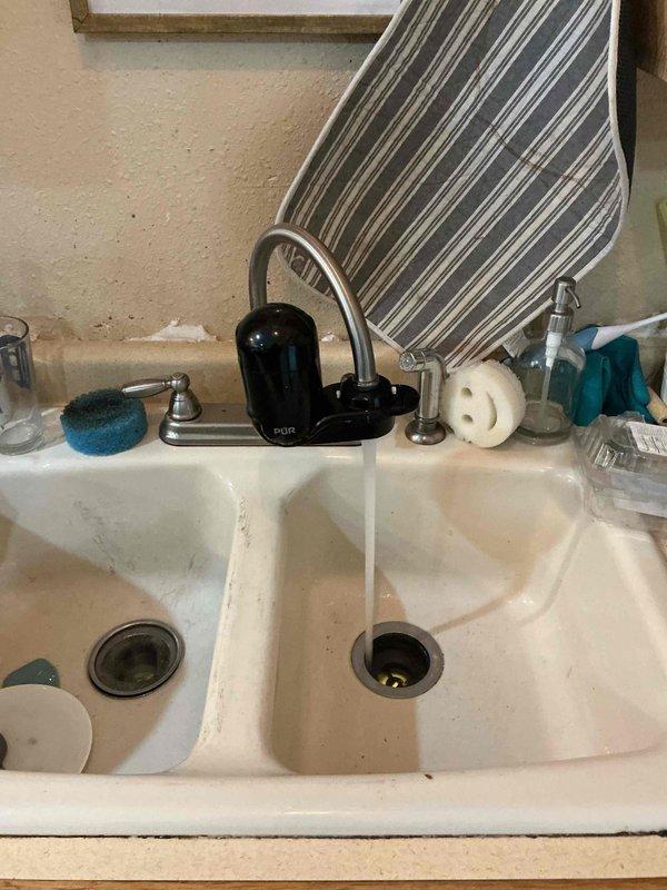 Successfully cleared clogged kitchen sink drain using auger technique. Identified underlying issue of improper pitch in basement piping, with excessive pitch near the stack causing drainage problems. Advised customer that a re-pipe of the kitchen sink line would be recommended as a permanent solution.