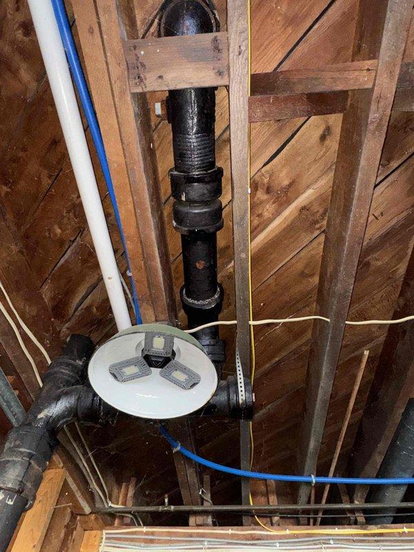 Inspected property for reported plumbing issues and identified multiple problems in the drainage system. Found two toilets backing up due to deteriorated cast iron drain piping that leaks during toilet usage. Exposed and examined the problematic plumbing infrastructure in the ceiling/wall area. Advised homeowner that professional drain cleaning services are required before toilet reinstallation can proceed, and provided estimates for resetting toilets once drain cleaning is completed.