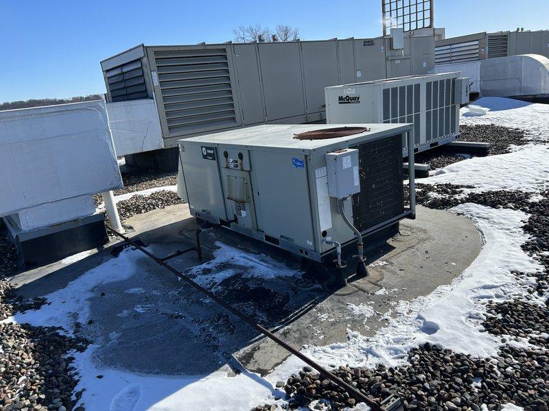 Responded to service call for five non-operational rooftop units. Diagnosed multiple issues including aged equipment requiring replacement on three units, a faulty VFD drive on a newly installed unit, and restored operation to one unit by replacing a defective Trane zone sensor. Identified shorted thermostat wire on Lennox unit caused by improper curb adapter installation and communicated findings to facility manager.