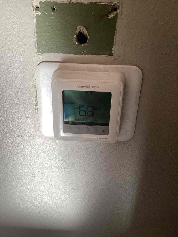 Responded to no heat complaint where customer was experiencing difficulty with programmable thermostat. Upon inspection, found thermostat was following a 62-degree schedule causing reduced airflow. Disabled programming to maintain manual setpoint, demonstrated proper thermostat operation including mode changes, and verified furnace functionality. Customer advised on thermostat options compatible with their two-stage furnace that would provide a larger display and simpler interface.
