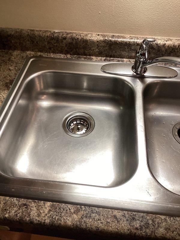 Successfully installed customer-supplied kitchen faucet and completed a PVC drain rebuild with new P-trap assembly in double basin stainless steel sink. Verified proper operation with no leaks in all connections and ensured smooth drainage through the newly installed plumbing components.