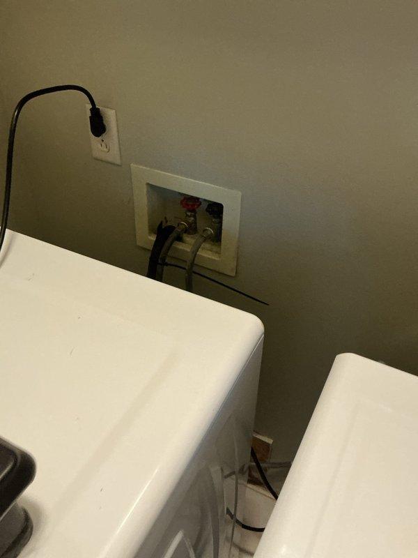 Responded to service call for clogged washing machine drain line which was determined to be frozen. Recommended installation of space heater in laundry room to thaw ice blockage, with follow-up professional steam service if needed. Additionally, cleared bathroom sink drain by removing significant hair and dental floss accumulation that extended beyond the pop-up assembly into the drain line.