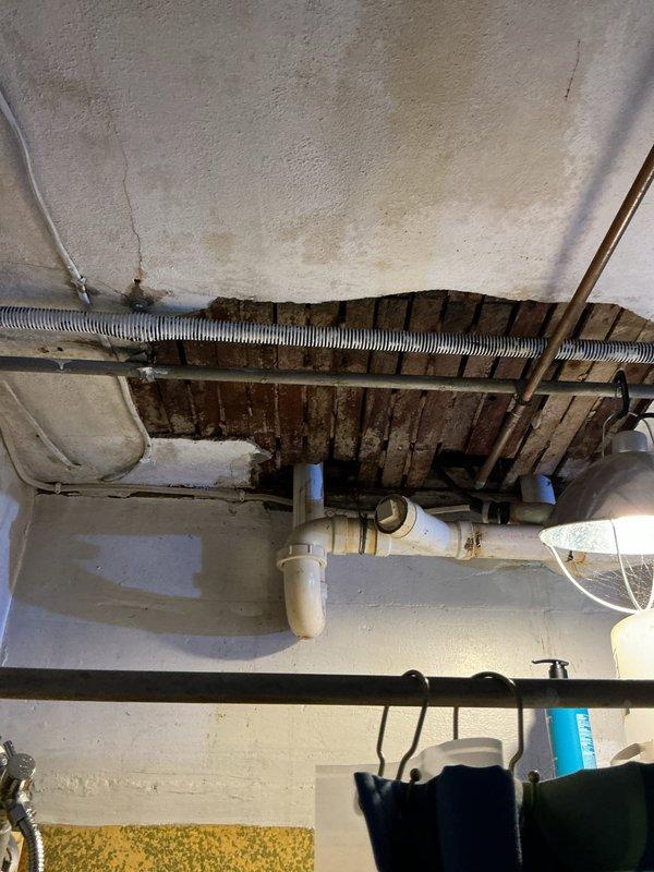 Responded to water leak call where customer experienced water intrusion into basement after frozen pipe thawed. Diagnosed issue as broken dishwasher valve due to freezing and improperly connected drain line. Shut off water supply to dishwasher, advised customer to contact appliance repair service, and reconstructed P-trap assembly under kitchen sink with proper connections to resolve drainage issue.