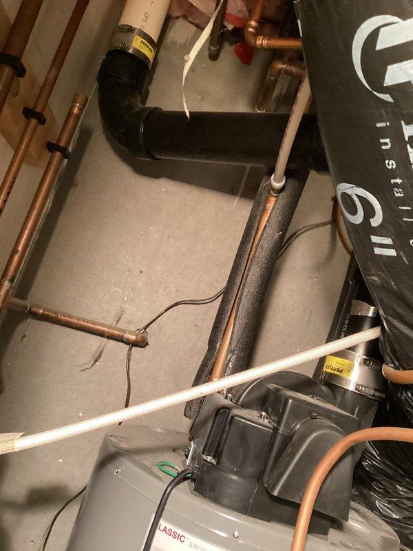 Responded to service call for Rheem Professional water heater not igniting. Upon inspection, discovered water leaking onto burner assembly, preventing proper pilot light operation. Diagnosed as tank leak requiring replacement. Provided customer with replacement estimate and explained options.