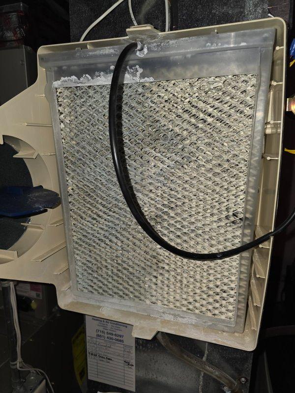 Responded to service call for non-functioning Aprilaire humidifier. Inspection revealed severely clogged humidifier pad causing water leakage due to improper drainage. Replaced the #35 filter, then test operated the system for 20 minutes. Humidifier now functioning properly with no leakage issues.