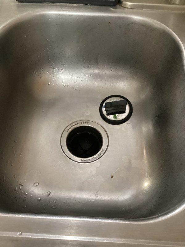 Replaced non-functioning InSinkErator garbage disposal unit due to age-related power reduction and complete failure. Removed old disposal system from kitchen sink, installed new disposal unit, and verified proper operation. Customer was consulted prior to replacement as requested.