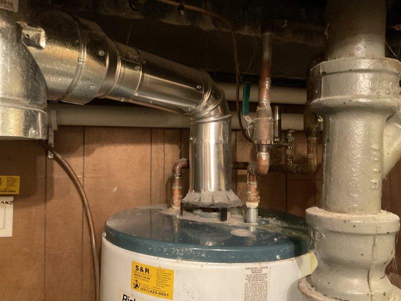 Successfully replaced a leaking, non-repairable 2006 model 50-gallon natural gas water heater with a new 50-gallon unit. Installation included proper connection of copper supply lines, gas line, and standard ventilation system with appropriate drainage setup.