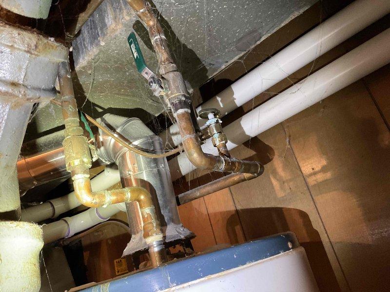 Successfully replaced a leaking, non-repairable 2006 model 50-gallon natural gas water heater with a new 50-gallon unit. Installation included proper connection of copper supply lines, gas line, and standard ventilation system with appropriate drainage setup.