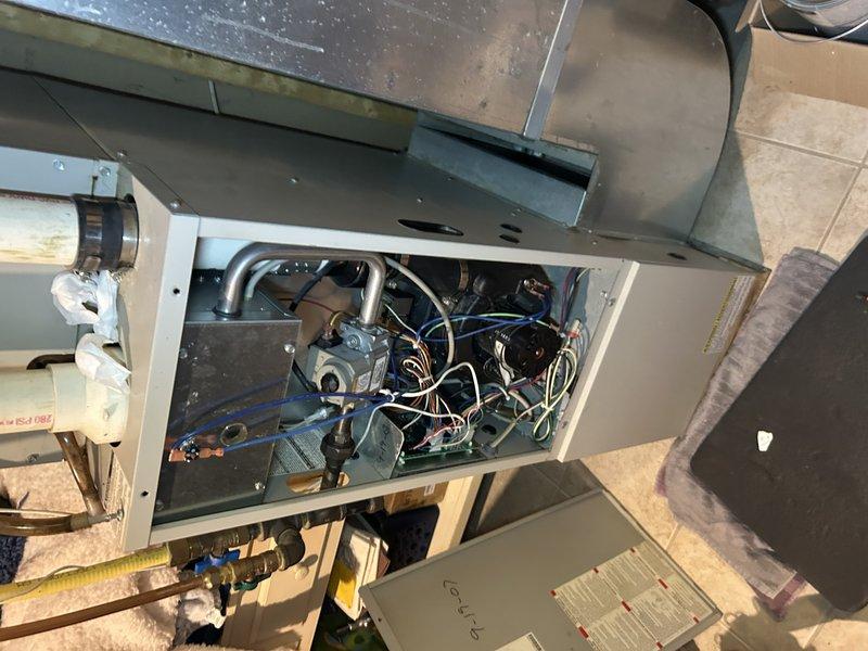 Responded to service call for furnace failure. Installed new hot surface ignitor and refilled condensate trap that customer had emptied, resolving exhaust gas backflow issue. Diagnosed intermittent pressure switch code despite switch functioning properly; determined control board replacement likely needed. Temporarily restored furnace operation and scheduled service advisor for follow-up evaluation of control board replacement.