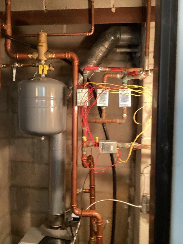 Diagnosed heating issue where bedroom and living room areas were not heating properly. Inspected boiler components including heat exchanger, burners, circulator pump, and zone valves. Purged air from the system and determined no water flow through bedroom zone, likely due to frozen lines. Recommended using space heaters directed at radiators to gradually thaw affected lines, with follow-up service after thawing is complete.