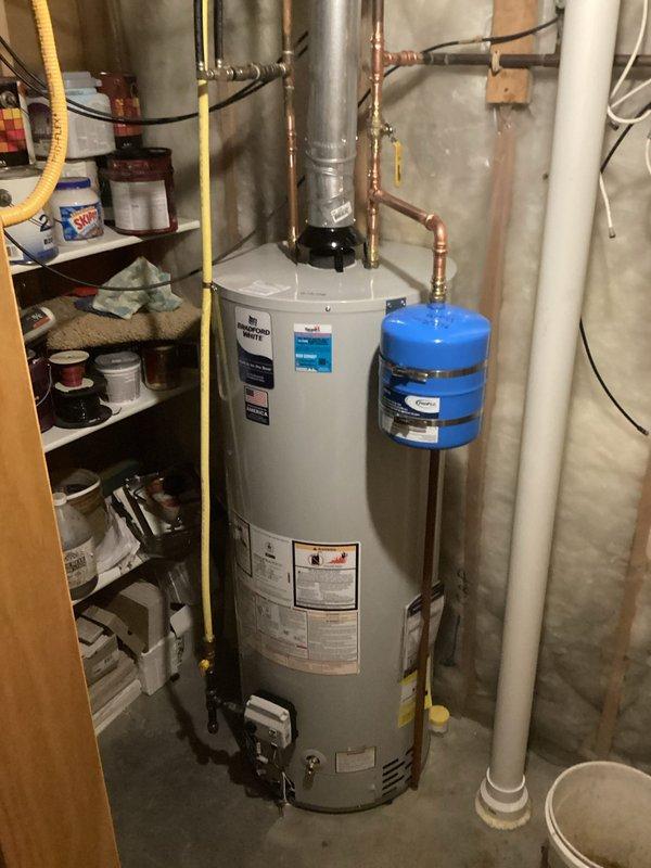 Successfully completed replacement of 50-gallon Bradford White natural gas standard vent water heater. Addressed initial atmospheric venting issue by applying heat to the flue and first four feet of piping with a hairdryer, which resolved the problem and established proper ventilation. Installation included all necessary connections to existing gas and water lines.