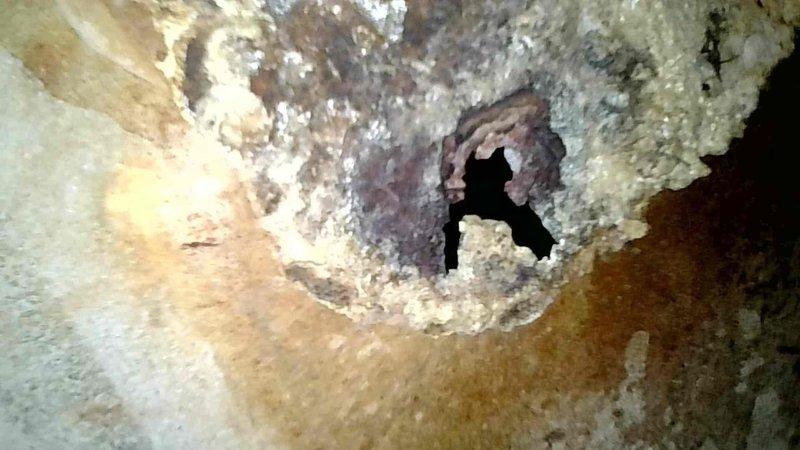 Responded to no-heat call for Lennox Pulse furnace. Upon arrival, determined unit was in safety lockout. Reset system and performed heat exchanger inspection, which revealed a significant hole in the primary heat exchanger. Due to carbon monoxide safety hazard, tagged and disabled the furnace. Documented damage with photos showing corrosion and heat exchanger perforation.