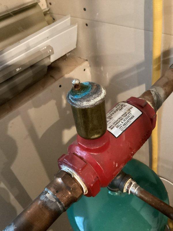 Responded to service call for heating inconsistencies in hydronic floor heating system and LP furnace not maintaining set temperature. Inspected 2004 Goodman furnace, identifying rust and moisture from collector box leak. Cleaned igniter and flame sensor, noted inducer motor drawing high amps indicating potential failure risk. Diagnosed hydronic floor heating issues as likely caused by stuck/closed zone valves and air pockets due to weak air eliminator. Recommended system purge/refill and air eliminator replacement to restore consistent heating performance.