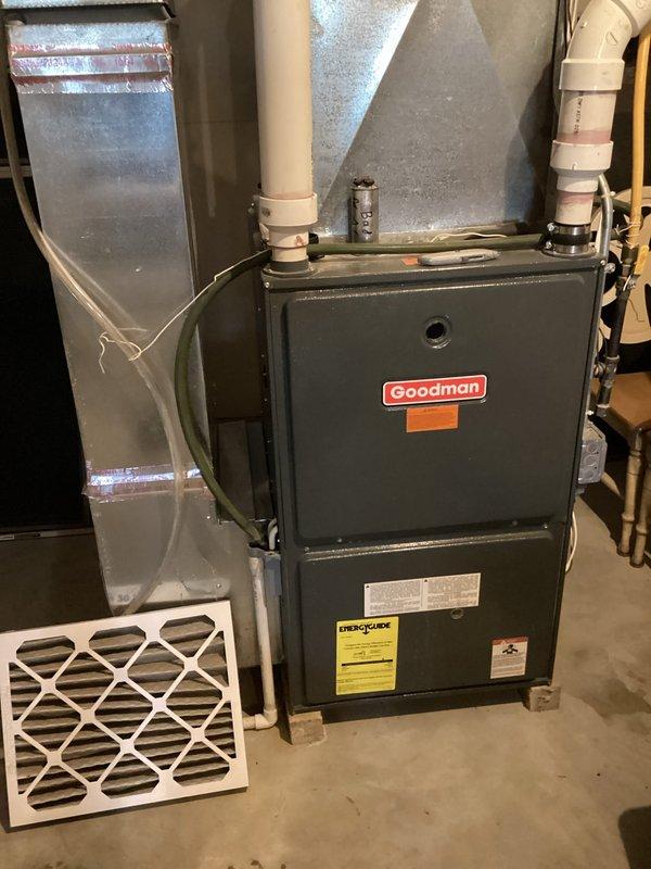 Responded to service call for heating inconsistencies in hydronic floor heating system and LP furnace not maintaining set temperature. Inspected 2004 Goodman furnace, identifying rust and moisture from collector box leak. Cleaned igniter and flame sensor, noted inducer motor drawing high amps indicating potential failure risk. Diagnosed hydronic floor heating issues as likely caused by stuck/closed zone valves and air pockets due to weak air eliminator. Recommended system purge/refill and air eliminator replacement to restore consistent heating performance.