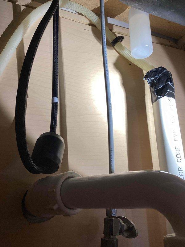 Responded to service call regarding dishwasher drainage issues. Inspection revealed 20+ year old unit with failing drain pump. Checked plumbing connections including PVC drain lines and air core ventilation pipes; all connections secure with temporary tape seals observed at pipe junctions. Advised customer that replacement of dishwasher unit is recommended rather than repair due to age of appliance.