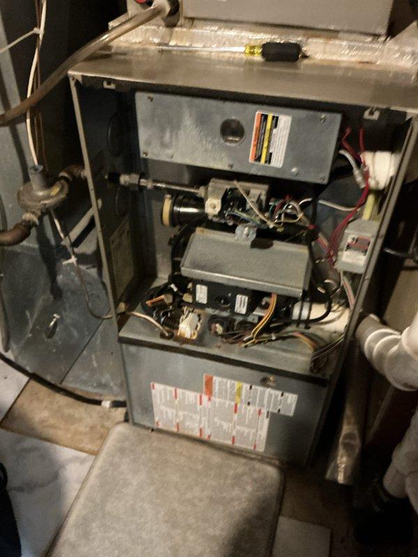 Performed diagnostic service on a 20-year-old Carrier furnace with no heat complaint. Identified failed secondary heat exchanger as primary issue, confirmed by visual inspection and photo documentation. Customer had previously reported sparks when bumping thermostat; found blown fuse caused by wiring contact during cabinet cleaning. Completed safety shutdown procedure due to heat exchanger failure. Customer opted to pursue replacement through home warranty program.