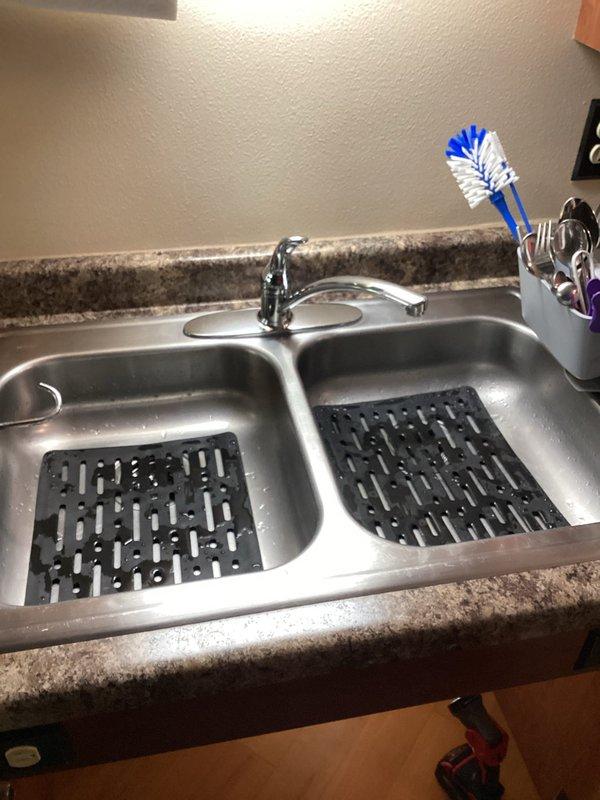 Responded to callback for recently replaced faucet that was leaking underneath. Determined leak was occurring through trim plate due to sink indentation. Applied silicone to deck plate to create proper seal and prevent further leakage.