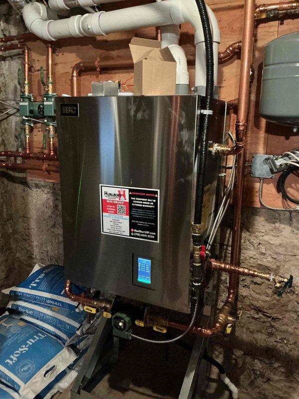 Responded to service call for one-month-old boiler system where in-floor heating had stopped functioning in sunroom and master bathroom. Diagnosed failed zone valve for the sunroom and determined that high demand from air handlers was causing supply temperature drops across all zones. Replaced defective Powerhead, which restored proper operation, with sunroom floor temperature increasing from 60°F to 71°F by completion of service.