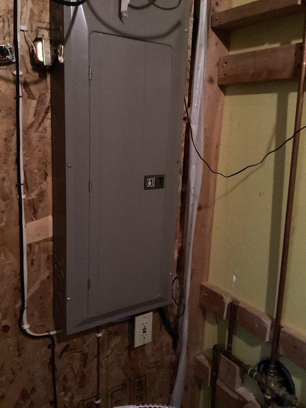 Responded to emergency service call for a blocked sump pump line at residential property. Upon inspection, discovered the main line to septic system was frozen. Performed initial assessment of electrical panel and plumbing connections, examining the PVC piping configuration at the floor drain. Referred customer to specialized drain cleaning company as the issue required dedicated equipment for frozen septic lines.