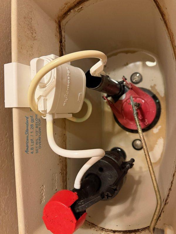 Diagnosed and repaired American Standard toilet (Model #4188A) that was continuously running due to a defective flapper with bubble formation on the gasket causing water leakage. Removed the compromised Fluidmaster Flush 'n Sparkle system and replaced both the flapper assembly and fill valve to restore proper tank operation and eliminate the persistent leak.