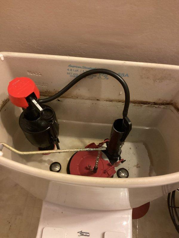 Diagnosed and repaired American Standard toilet (Model #4188A) that was continuously running due to a defective flapper with bubble formation on the gasket causing water leakage. Removed the compromised Fluidmaster Flush 'n Sparkle system and replaced both the flapper assembly and fill valve to restore proper tank operation and eliminate the persistent leak.