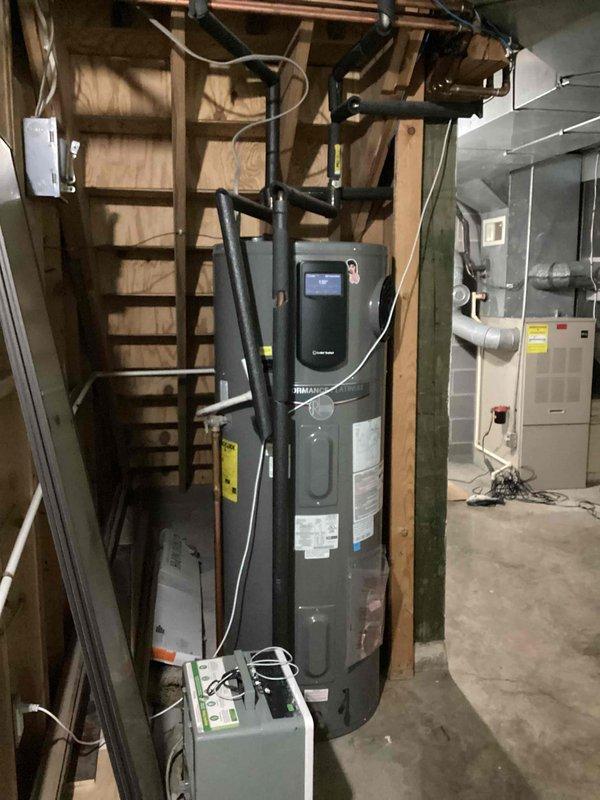 Inspected complex integrated HVAC system with radiant in-floor hydronic heating (propane), secondary oil furnace, and AC components. Evaluated existing thermostat configuration which controls multiple heating systems through single control point; determined current thermostat could remain functional despite unconventional wiring setup. Provided customer consultation regarding Triangle Tube boiler and oil furnace operation within the integrated system.