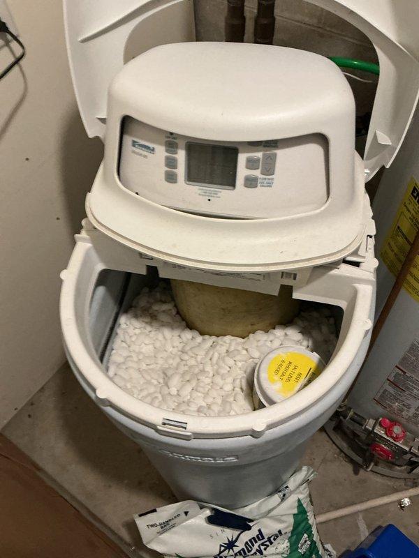 Inspected non-functional Kenmore water softener (approximately 6-7 years old) at tenant property. Discovered significant dam formation in salt chamber. Documented current system condition including salt level and control panel status. After assessment, removed existing salt and performed diagnostic testing. Prepared unit for installation of customer-provided replacement softener. Photographed electrical panel for reference during service. Obtained landlord approval before proceeding with work.