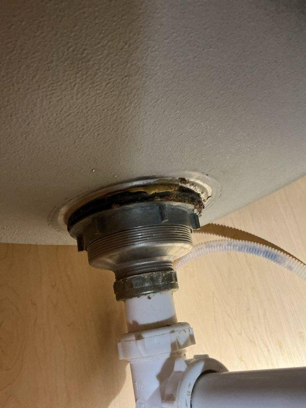 Repaired kitchen sink leak by replacing faulty basket strainers and continuous waste assembly. Removed deteriorated P-trap and installed new components to resolve drainage issues. All connections were tested and confirmed watertight with proper seals at fixture penetrations.