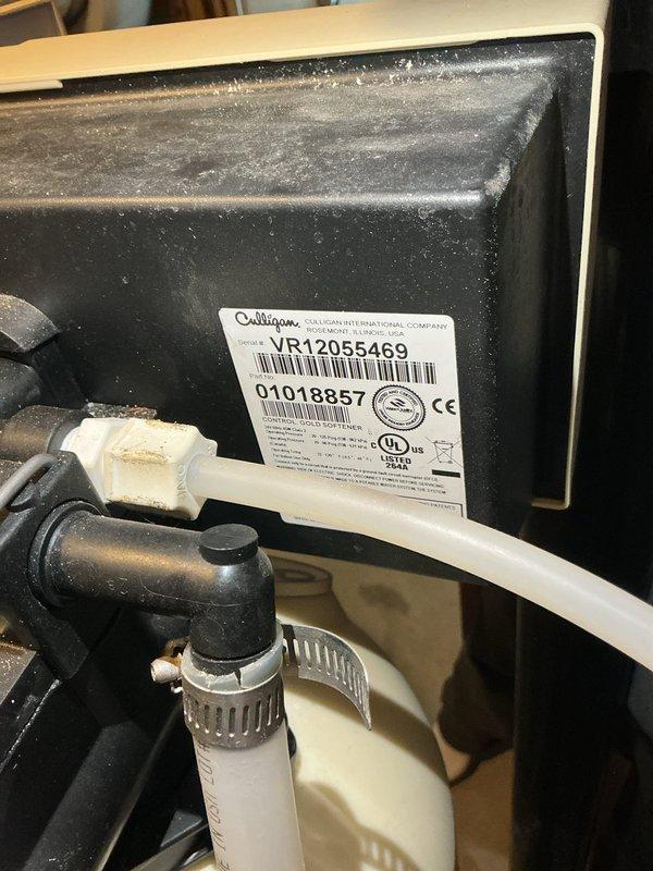 Diagnosed and repaired Culligan Gold Series water softener (SN: VR12055469) that was continuously discharging water and failing to progress through regeneration cycles. Found control head stuck in discharge position showing error code 1H. Serviced unit by lubricating piston seals, which resolved the cycling issue and restored proper water softening function.