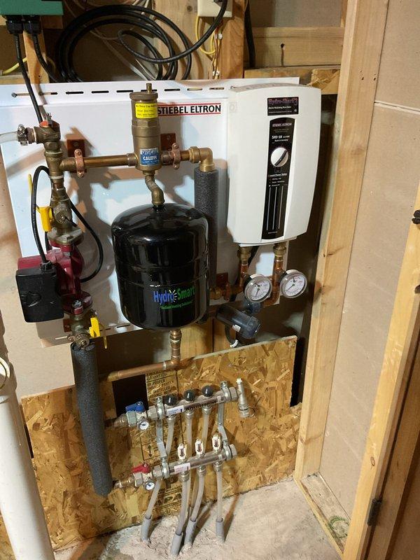 Responded to service call for a leaking geothermal system that was recently installed. Identified a dripping valve on the pump station and resolved the issue by tightening the packing nut, successfully stopping the leak. Documented the repair with photographs of the system installation for service records.