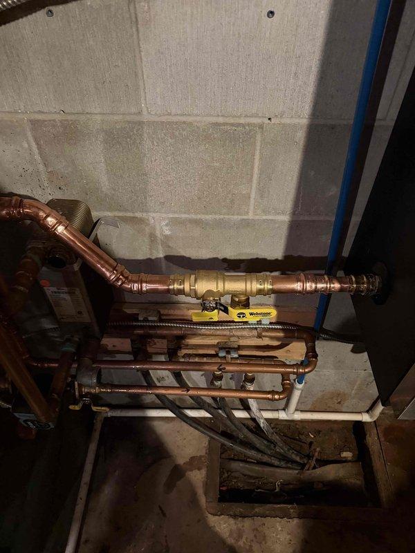 Repaired heating system by bypassing clogged plate heat exchanger, directly repiping boiler connections with copper piping. Replaced fill valve and performed complete system bleed to restore proper circulation and heating efficiency.
