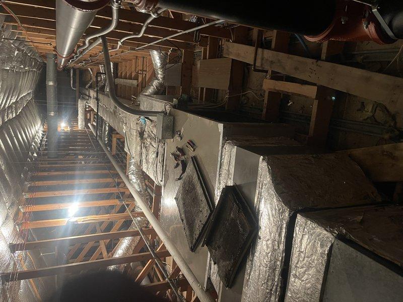 Responded to service call for non-functioning air handler in attic. Diagnosed seized blower motor as evidenced by frozen shaft and inability to rotate. Removed belt and pulley assembly for further inspection. Documented extensive rust and dust accumulation on housing components. Submitted motor replacement specifications to parts department for customer estimate.