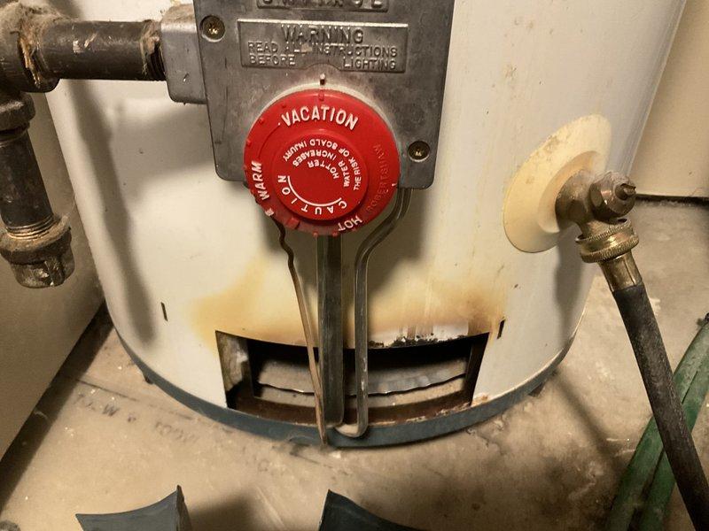 Replaced failed thermocouple on 2001 Rheem natural gas water heater that was not producing hot water. Noted significant buildup and corrosion on components. Due to the unit's age (22 years), recommended full water heater replacement as the more reliable long-term solution rather than continuing with component repairs.
