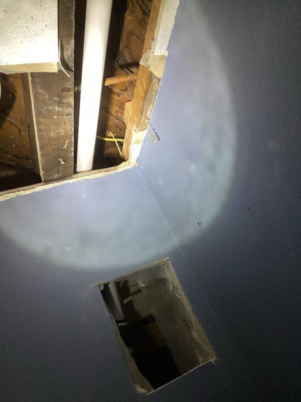 Responded to water leak service call where customer reported water leaking through basement ceiling when using kitchen sink and dishwasher. Upon inspection, discovered a hole in the galvanized pipe connecting the kitchen sink to the main stack. After presenting repair options, replaced the entire drain line to the kitchen sink, installed new P-trap, and added a tutor vent to ensure proper drainage and eliminate the leak.