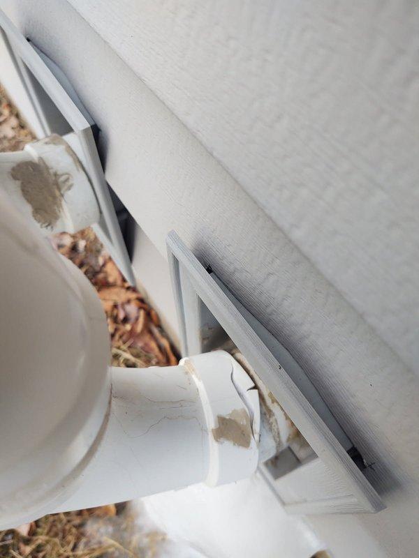 Repaired cracked PVC exhaust pipe by installing a Fernco connector and new piping. Ice buildup was observed at the base of the exterior pipe. Customer was informed that a permanent glue fitting could be installed in warmer weather if needed, but approved the current repair solution.