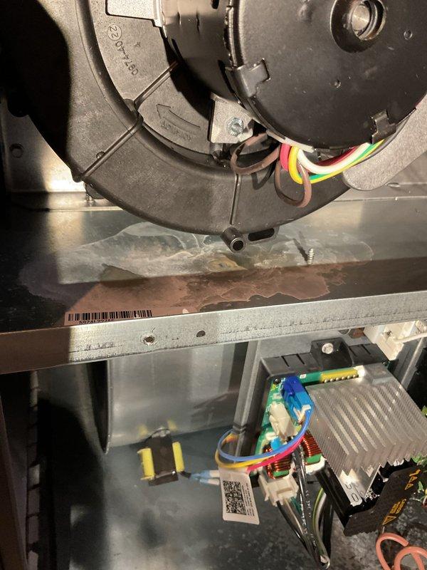 Performed annual maintenance on 1-year-old furnace, which revealed improper installation of exhaust components. Discovered PVC pipe was not properly secured with glue/silicone to draft inducer, causing exhaust leakage at connection point and 45° elbow. Removed compromised section, installed new fittings with proper adhesive application, and applied silicone around street fitting in draft flue. System tested for 25 minutes with no further leaks detected.