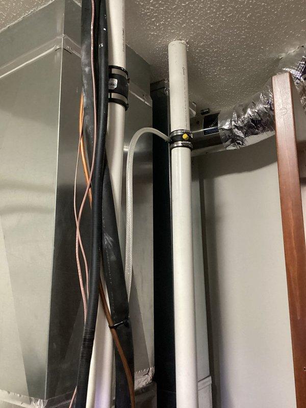 Repaired gas leak at furnace by removing and reinstalling nipple fitting with proper pipe dope and tightening. Installed in-line drain on intake to address customer's concerns about condensation backflow, with drain line routed to floor drain. Performed leak test throughout utility room with no additional leaks detected.