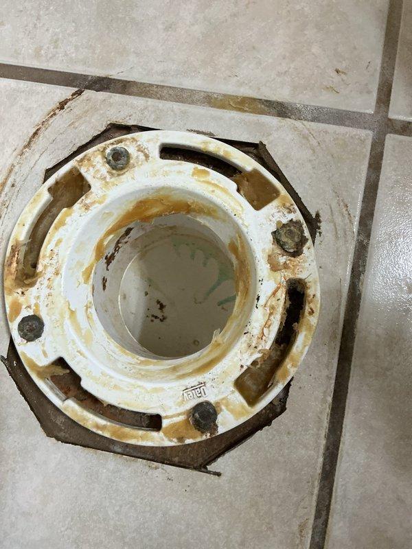 Responded to emergency service call for toilet leaking and flooding bathroom. Diagnosed failed wax seal and broken closet flange causing water to escape from base during flushing. Replaced damaged closet flange and installed new wax ring, successfully resolving the leak.