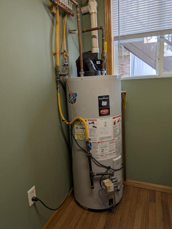 Diagnosed water heater blower motor making grinding noise; determined bearings are failing in the motor assembly. Inspected for reported gas odor and verified all connections. Provided customer with replacement options for water heater unit and enrolled them in our friends and family program for future service.