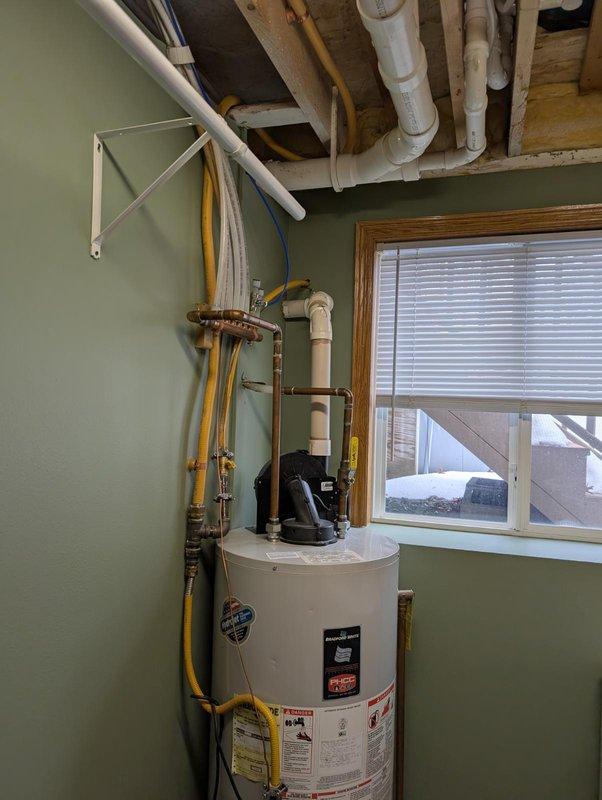 Diagnosed water heater blower motor making grinding noise; determined bearings are failing in the motor assembly. Inspected for reported gas odor and verified all connections. Provided customer with replacement options for water heater unit and enrolled them in our friends and family program for future service.