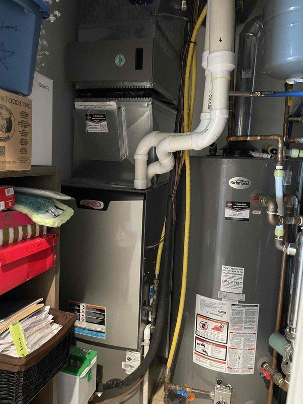 Responded to service call regarding disconnected intake pipe on Lennox furnace. Removed the existing taped connection, applied silicone adhesive to properly secure the 12-4 inlet pipe, and reconnected the intake assembly. Post-repair testing confirmed proper system operation with no further issues noted.