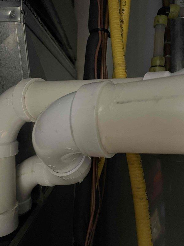 Responded to service call regarding disconnected intake pipe on Lennox furnace. Removed the existing taped connection, applied silicone adhesive to properly secure the 12-4 inlet pipe, and reconnected the intake assembly. Post-repair testing confirmed proper system operation with no further issues noted.