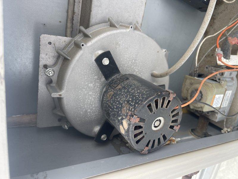 Responded to no heat complaint at corporate office. Diagnosed failed combustion blower on rooftop unit serving outside offices. Took photos documenting the condition of blower motor assembly and accessible internal components. Prepared documentation for replacement part ordering.