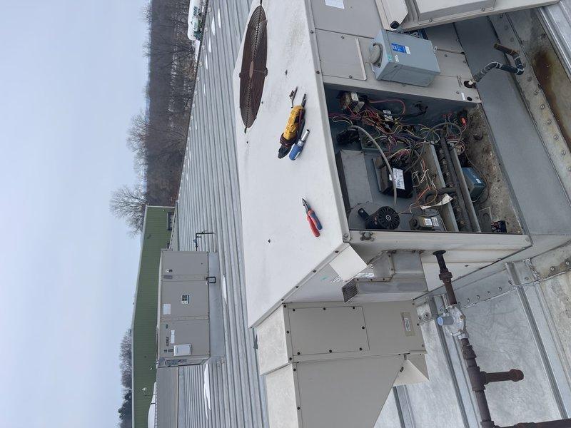 Responded to no heat complaint at corporate office. Diagnosed failed combustion blower on rooftop unit serving outside offices. Took photos documenting the condition of blower motor assembly and accessible internal components. Prepared documentation for replacement part ordering.