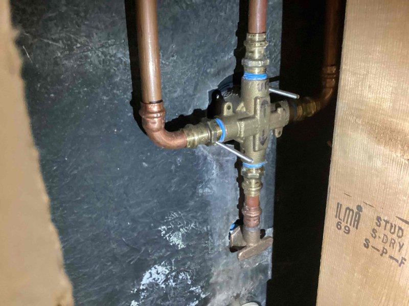Completed 5-hour repair involving installation of customer-supplied shower trim kit assembly. Created access point to wall cavity, installed mixing valve assembly with proper copper pipe connections, and completed all necessary plumbing connections for shower functionality.