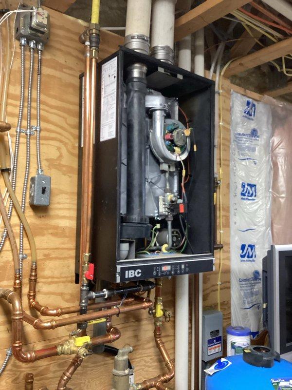 Responded to service call for IBC boiler experiencing intermittent operation and combustion blower issues. Diagnosed fan motor problem likely caused by dislodged motor cover that became wedged against the motor wheel, causing imbalance and irregular fan speed cycling. Performed temporary motor adjustment to restore operation, but recommended replacement of motor and complete system tuneup due to lack of maintenance over past three years.