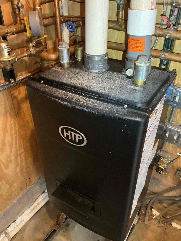Responded to no heat/hot water call for HTP boiler system. Diagnosed failed ignition sequence and identified leaking at copper valve assembly showing significant oxidation. System requires replacement; recommended customer speak with comfort advisor regarding options.