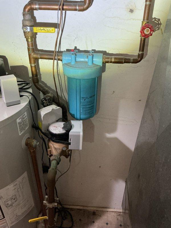 Replaced a damaged washer box, installed a new 10-inch whole house water filter system, and upgraded existing gate valve to a ball valve to address leak in the main water supply pipe. All components were properly connected to the existing copper pipe network with appropriate fittings and pressure tested to ensure system integrity and eliminate the previously observed water mist issue.