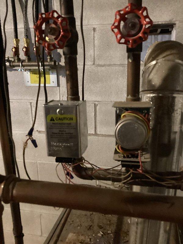 Responded to service call for Lennox boiler system that was heating but not circulating water properly. Upon inspection, discovered the auto fill valve was shut off, preventing proper pressure maintenance. Restored system operation by opening the valve, bringing boiler to correct pressure, and purging air from the lines. Additionally, replaced a malfunctioning zone valve on the main level that was intermittently sticking, which had been causing continuous heating issues. Verified complete system functionality after repairs.